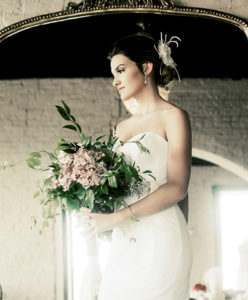 Model Courtney Haag The Amaia Dress from Edith Elon, $2,160 Florals by Nance Floral Shoppe Headpiece by Head Candi, $188 Earrings from Head Candi, $38 Belt by Head Candi, $38