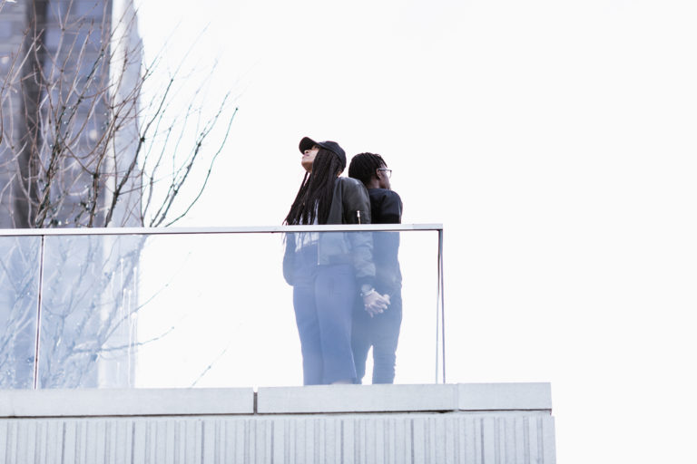 storyblocks-two-people-in-all-black-clothing-standing-outside_S3WHa1FhYP