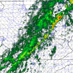 Weather radar map showing a diagonal line of thunderstorms from southwest to northeast with heavy rainfall (yellow/orange) and lighter rain (green).