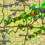 Weather radar map showing a line of strong storms across southern Indiana toward Cincinnati, with red/orange indicating heavy rainfall and thunderstorms; major cities labeled (Indianapolis, Bloomington, Louisville, Cincinnati).