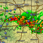 Radar image showing widespread thunderstorms around Louisville, with red/orange core cells along I-65/I-71 and lighter rain to the north and east; green areas indicate lighter rainfall.