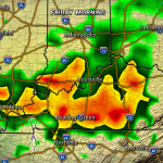 Weather radar map of Kentucky and Tennessee showing heavy rainfall around Louisville, Bowling Green, and Nashville with green to red color codes.