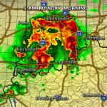 Weather radar map at 5 AM Monday showing a strong storm near Indianapolis, with red/orange bands moving toward Louisville and green areas indicating lighter rain.